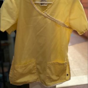 Yellow landau scrub top size small with white lace trim detail